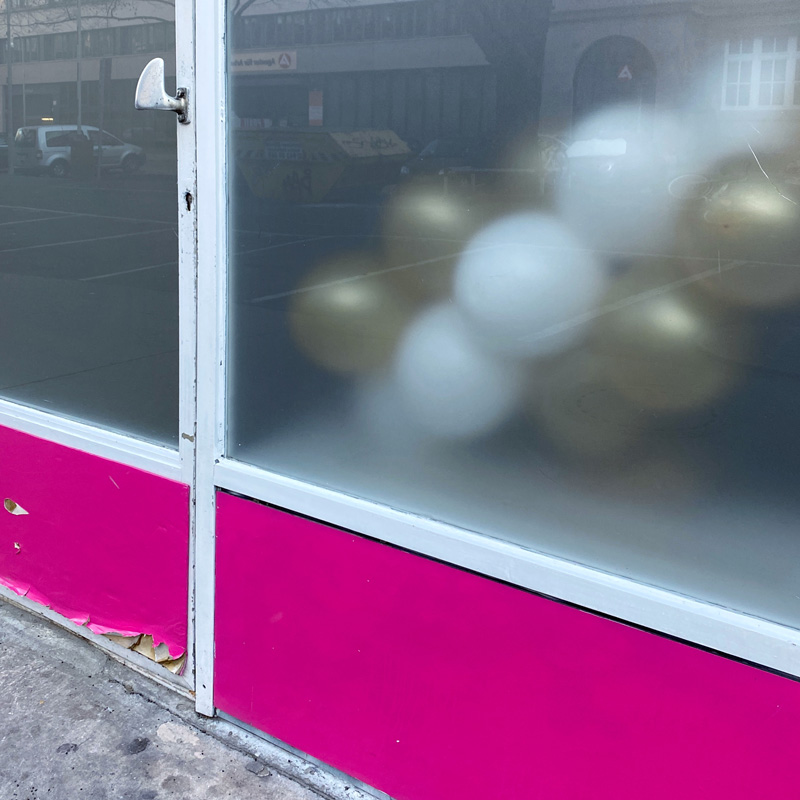 Photo of balloons behind a transulcent window